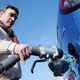 A man plugs his electric car into a charging cable.